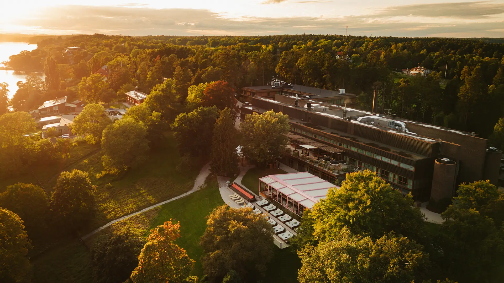Ellery Beach House from above Drone view of Ellery Beach House surrounded by greenery at sunset.