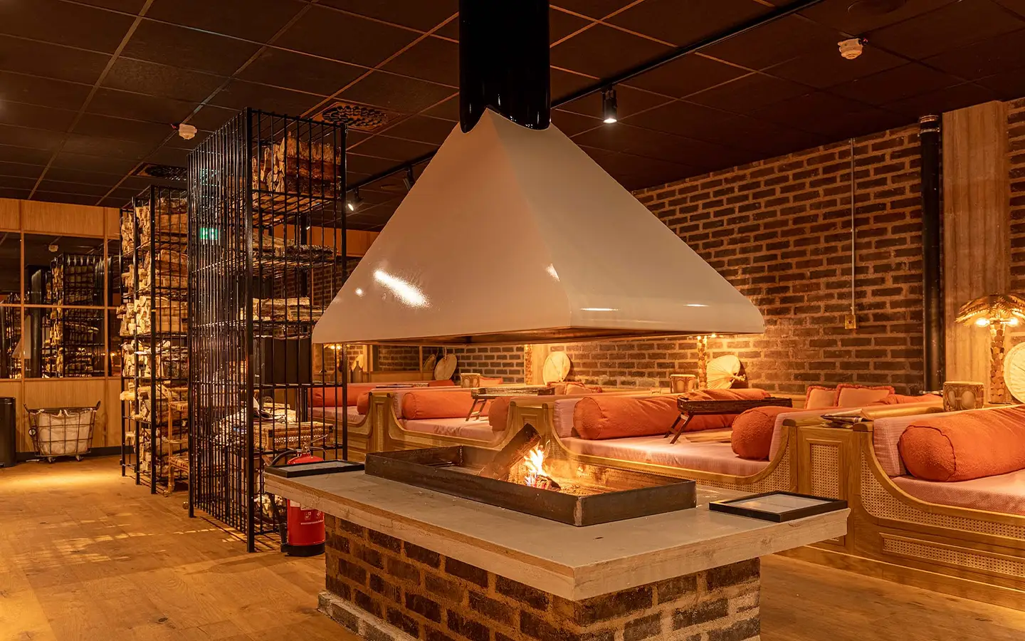 Fire relax lounge with daybeds and open fire at Coco Beach Club at Ellery Beach House in Stockholm.