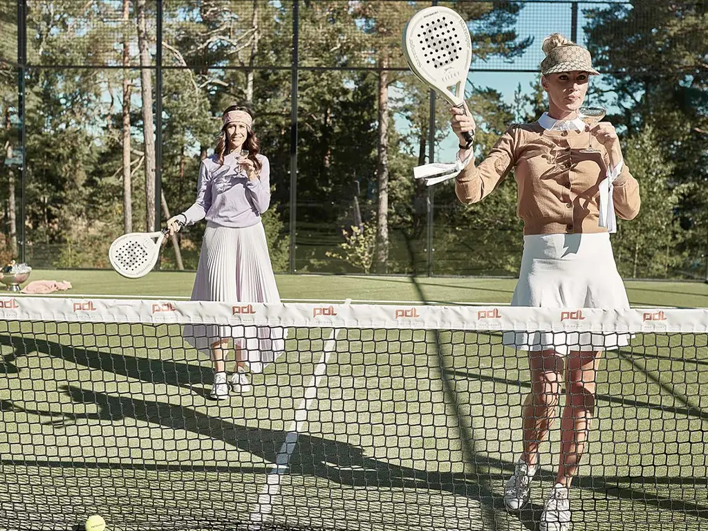 Padel at Ellery Beach House Stockholm Padel players on an outdoor court at Ellery Beach House near Stockholm