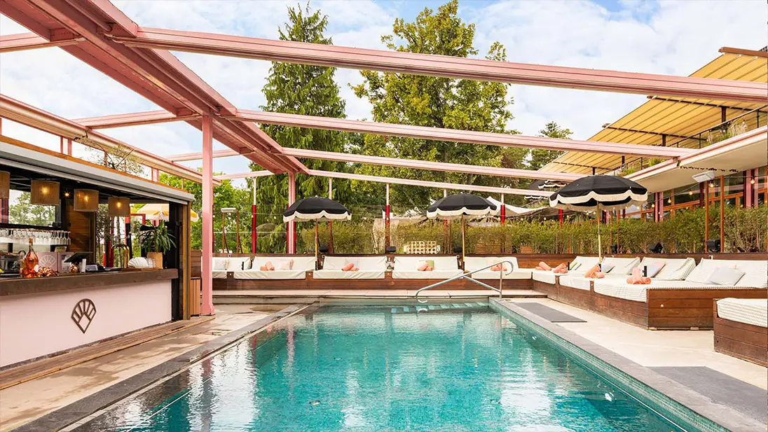 Pool area with sun loungers at Coco Beach Club at Ellery Beach House in Stockholm.