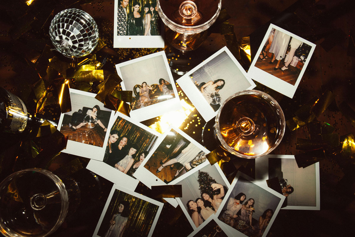 Polaroid photos, champagne glasses and party decorations during a celebration at Ellery Beach House near Stockholm