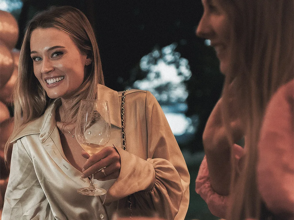 Polaroid photos, champagne glasses and party decorations during a celebration at Ellery Beach House near Stockholm