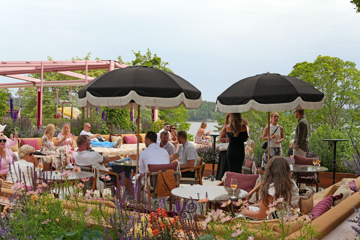 Guests at Coco Patio overlooking the water at Ellery Beach House