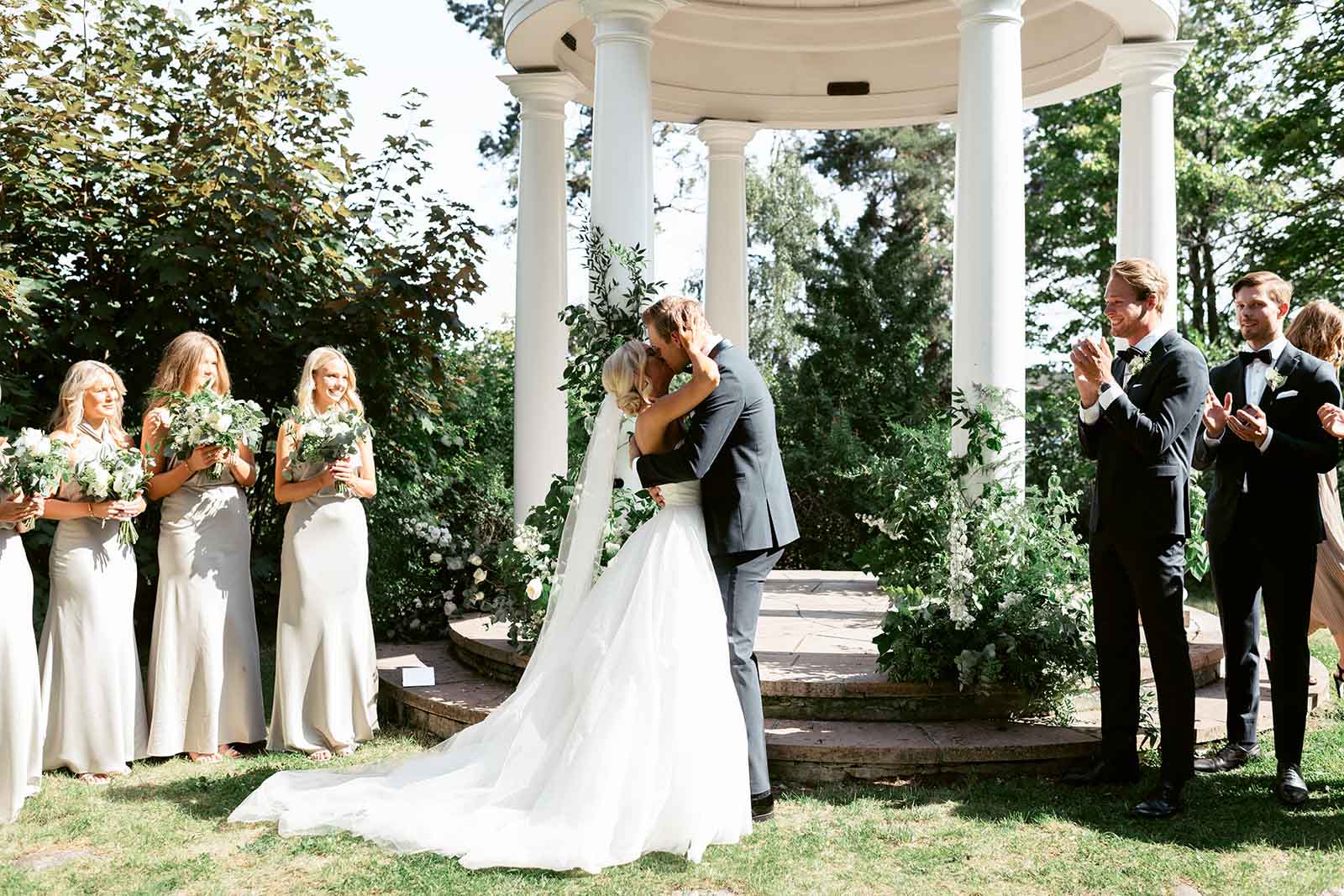 A Kiss by the Water Wedding couple kissing during their ceremony at Ellery Beach House on Lidingö near Stockholm
