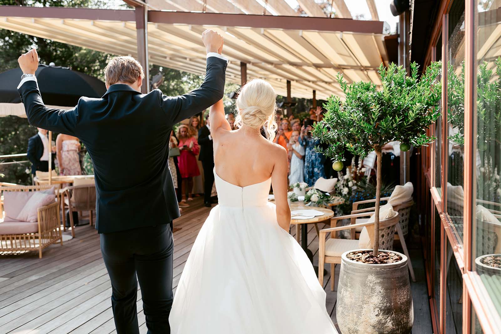 The Couple’s Grand Entrance Wedding couple making their entrance on the terrace during a wedding at Ellery Beach House